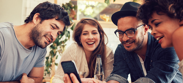 Friends looking at phone at table