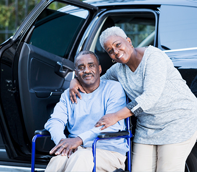 Couple at van, man in wheelchair