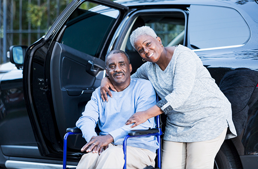 Couple at van, man in wheelchair