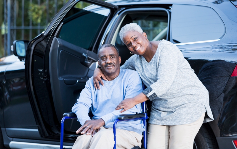 Couple at van, man in wheelchair